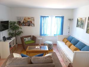 a living room with a couch and a table at Aldeia Formosa - Cabanas de Tavira in Cabanas de Tavira