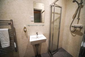 a bathroom with a sink and a shower at Yorkshire Dales Lodge 10 Ensuite in Richmond +30 photos