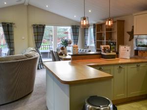 a kitchen with a counter and a dining room at Griffon Lodge - Uk3469 in Felton