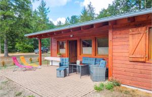 a patio with chairs and a table in front of a cabin at Beautiful Home In Merzalben With Kitchen in Merzalben