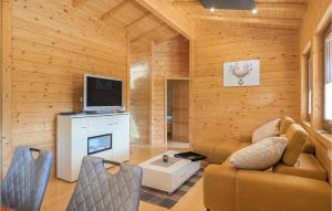 a living room with a couch and a television at Beautiful Home In Merzalben With Kitchen in Merzalben