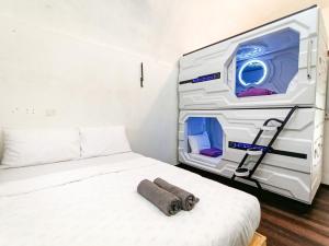 a small bedroom with a bed with a largeatronatronatronatron at Genting Greenwoods Tiny Houses & Events Hall in Genting Highlands