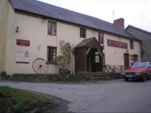 a building with a car parked in front of it at Seven Stars Inn in Builth Wells