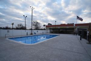 an empty swimming pool in front of a building at Best Western Huntsville in Huntsville