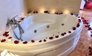 a white bath tub with red hearts around it at VV APARTAMENTOS ESTRELLA DEL NORTE in Icod de los Vinos