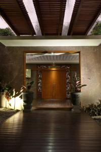 a front door of a building with two potted plants at COZY Boutique Guest House in Malang