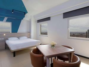 Postel nebo postele na pokoji v ubytování ibis budget Phnom Penh Riverside