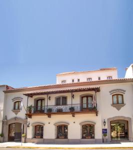 a large white building with a balcony at Solar De La Plaza in Salta