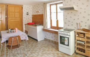 Una cocina con una mesa, una estufa y un fregadero. en Cozy Apartment In Plaine With Wifi, en Plaine