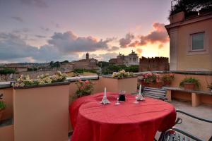 a table with a red table cloth on a balcony at Colosseum Colosseo in Rome