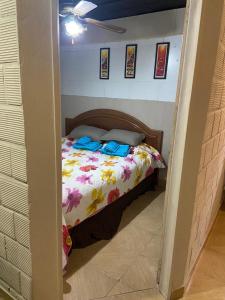 a bedroom with a bed with a floral bedspread at "Edificio Don Luis" en Bajada Vieja in Posadas