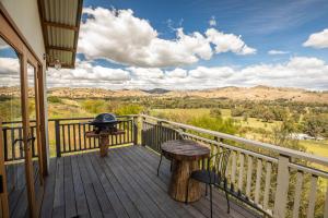 a balcony with a grill and a table and chairs at WATTLE TREE HILL in Gundagai