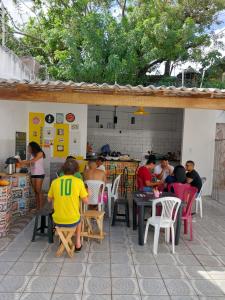 a group of people sitting at tables in a restaurant at Guará Hostel in São Luís