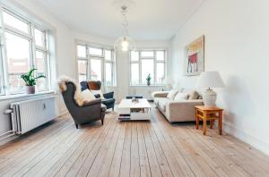 sala de estar con sofá y mesa en Elegant, evocative and cosy home in Østerbro with a panoramic view. Eco-friendly. 1km harbour/ beach, 3km- city center, 13km-airport. en Copenhague