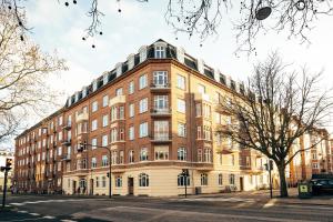 a large brick building on the corner of a street at Elegant, evocative and cosy home in Østerbro with a panoramic view. Eco-friendly. 1km harbour/ beach, 3km- city center, 13km-airport. in Copenhagen