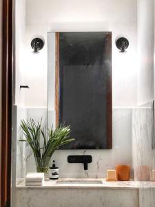 a bathroom with a sink and a mirror at Hotel Atia in Guadalajara