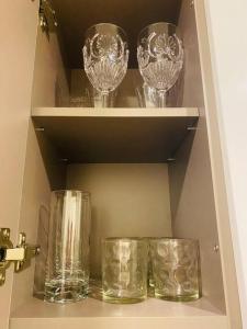 tres vasos sentados en un estante en un cajón en EXCLUSIVO APARTAMENTO BOGOTÁ, en Bogotá