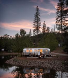a silver trailer parked next to a body of water at AutoCamp Yosemite in Midpines
