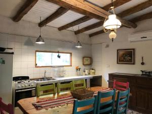 a kitchen with a table and chairs and a sink at LOS CHAÑARES CASAS DE CAMPO in Rama Caída