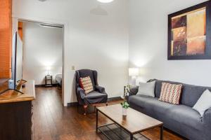a living room with a couch and a table at Centric NY Style Loft w/King bed in Rochester