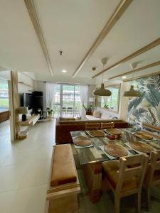 a living room with a table and a couch at 3BD/3BA Penthouse - Tropical Oasis in Pico de Loro in Patungan