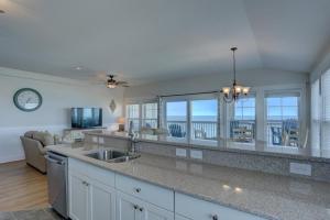 a large kitchen with a view of the ocean at TSC404 Seaclusion Oceanfront Elevator in Kill Devil Hills