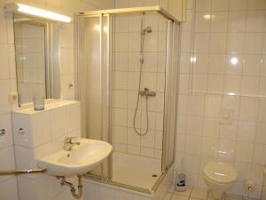 a bathroom with a shower and a sink and a toilet at Ferienwohnung direkt am Hafen in Fehmarn-Orth in Orth