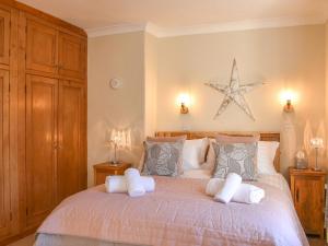 a bedroom with a large bed with two white pillows at Clouds End in Grassington