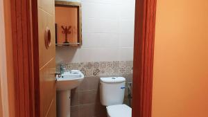 a bathroom with a toilet and a sink at Salòs del Comfort in Oualidia