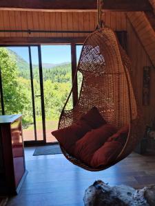 a hanging hammock with a pillow in a room at Alpinas de Sollipulli refugio sollipulli in Melipeuco