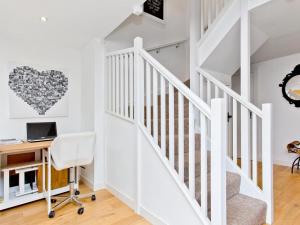 a white staircase in a home with a desk and a heart wall at Dowies Mill Lane in Edinburgh