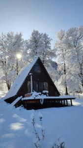 a cabin with snow on it in a field at Alpinas de Sollipulli refugio sollipulli in Melipeuco