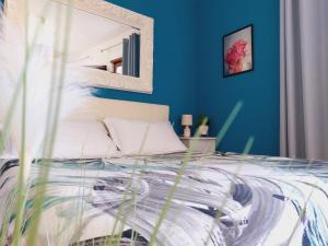 1 dormitorio con 1 cama con pared azul en Verona Rooms en Verona