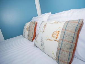 a white bed with two pillows on it at Jill Hoot-uk36796 in Foulsham