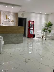 a lobby with a red coke machine and chairs at HOTEL LIFE IJUI in Ijuí