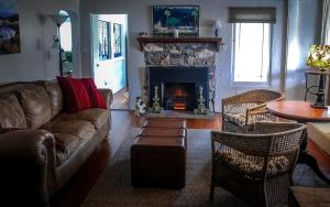 a living room with a couch and a fireplace at Rio Sierra Riverhouse in Three Rivers
