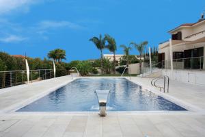a swimming pool in the middle of a house at Villa Leonidas in Protaras
