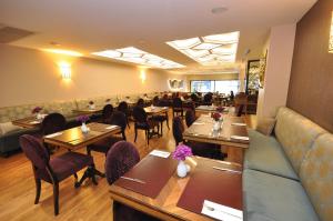 a restaurant with tables and chairs and a couch at Neorion Hotel - Special Class in Istanbul