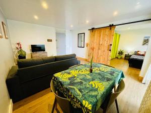 a living room with a couch and a table at Tunui City Apartment - Quiet & Pool in Papeete