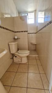 a bathroom with a toilet and a sink at Casa a pie de playa isla de la piedra in Mazatlán