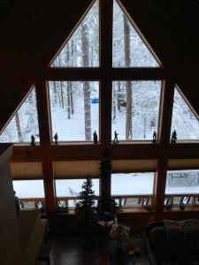 a large window in a room with snow outside at Chalet 5 Aspens in Prescott