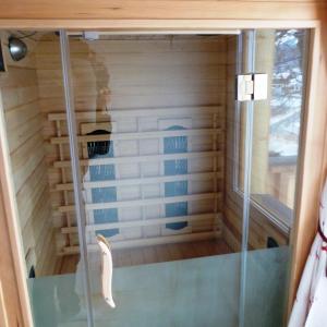 a sauna with a glass door in a room at Jägerchalet in Uttendorf