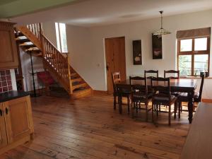 a kitchen and dining room with a table and chairs at Comfortably Crolly Holiday Home in Letterkenny