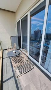 a balcony with a table and chairs on a balcony at Aston Apartment Batam Floor 21 in Nagoya