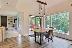 a dining room and living room with a table and chairs at 2215 - Chalet à louer à Alma (CITQ: 311069) in Alma