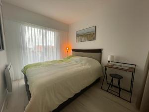 1 dormitorio con cama, mesa y ventana en Appartement Arcachon, 2 pièces, 3 personnes - FR-1-474-230, en Arcachon