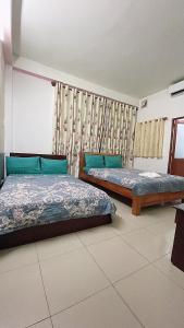 מיטה או מיטות בחדר ב-Phước Tài Hotel