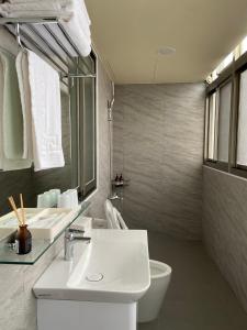 a bathroom with a white sink and a toilet at 小島上island in Dongyin