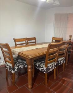 a wooden table with four wooden chairs and a table at Casa Fuerteventura in Santiago