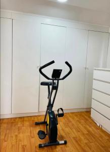 a exercise bike in a room with white cabinets at Casa Fuerteventura in Santiago